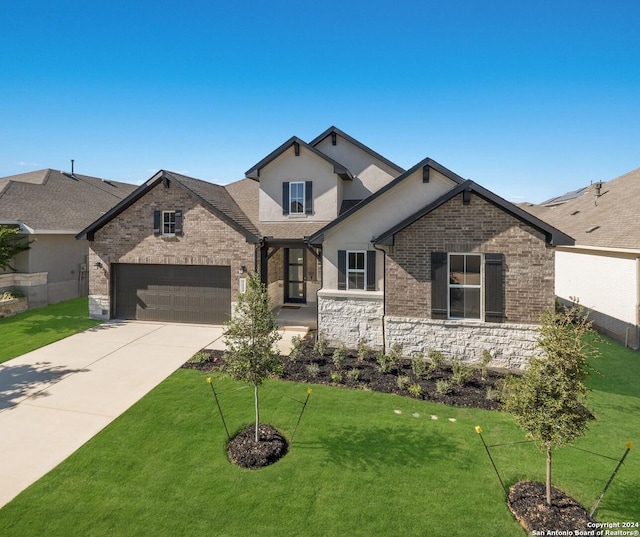 view of front of home featuring a garage and a front yard