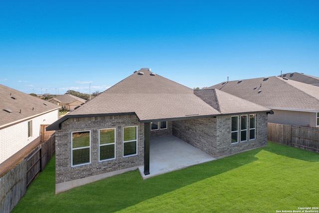 back of house featuring a yard and a patio area