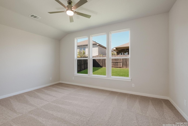 carpeted empty room featuring vaulted ceiling and ceiling fan