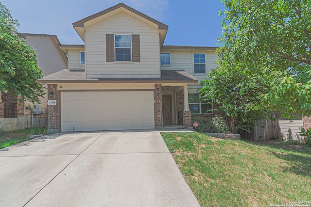 view of front of home featuring a garage and a front yard