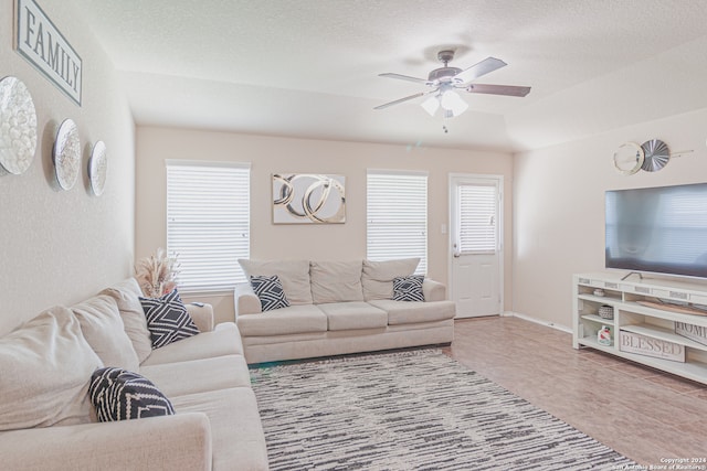 tiled living room featuring a textured ceiling and ceiling fan