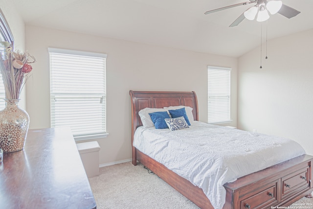 bedroom with multiple windows, ceiling fan, and light colored carpet