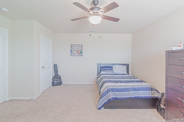 bedroom featuring light carpet and ceiling fan