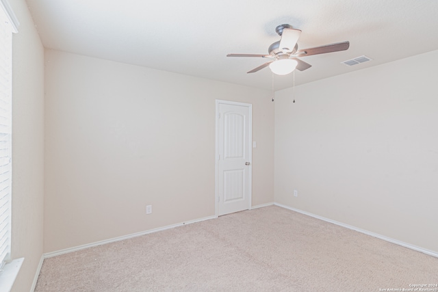 empty room with ceiling fan and carpet flooring