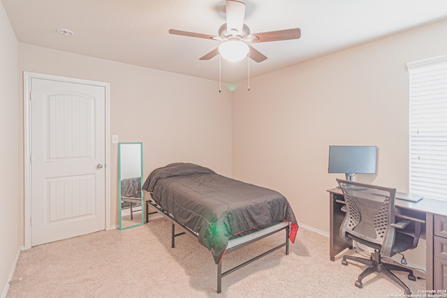 bedroom featuring light carpet and ceiling fan