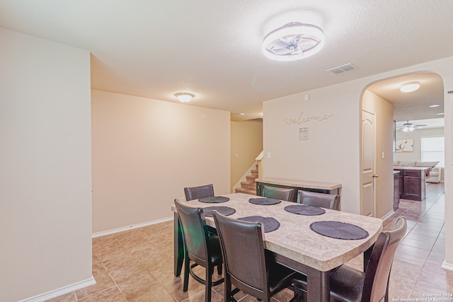 tiled dining room with ceiling fan