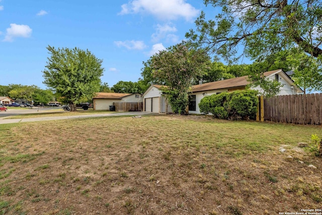 view of front of home featuring a garage and a front lawn