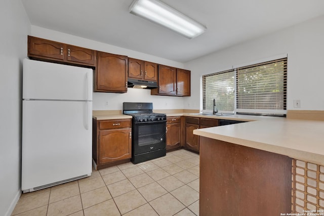 kitchen featuring black range with gas cooktop, sink, light tile patterned floors, white refrigerator, and kitchen peninsula