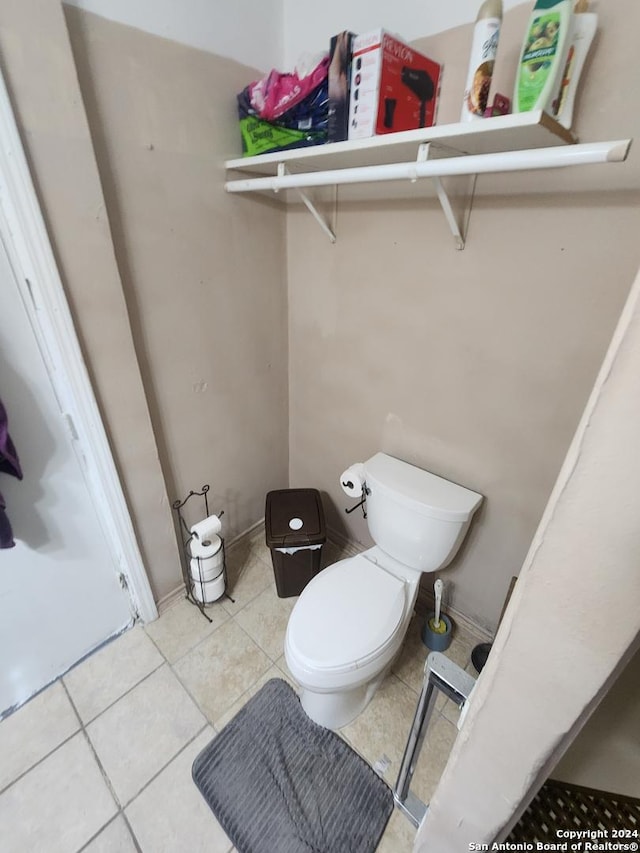 bathroom featuring toilet and tile patterned flooring