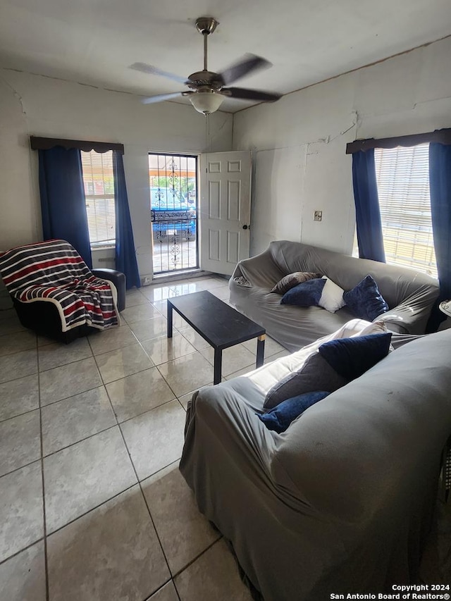 tiled living room featuring ceiling fan