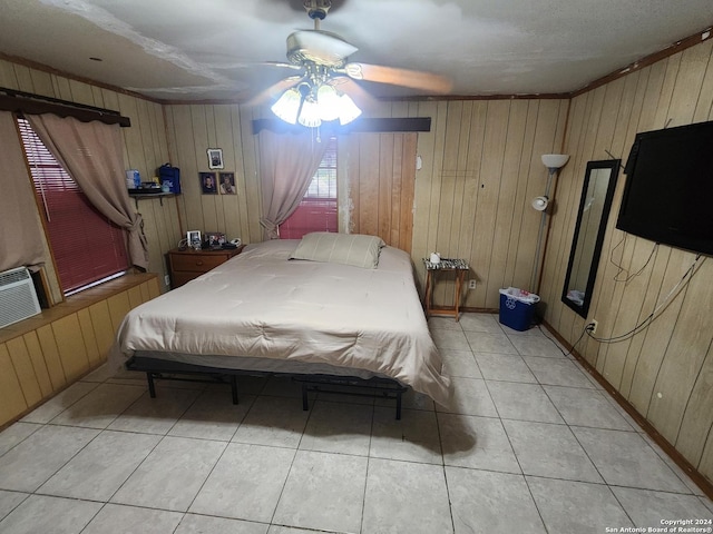 tiled bedroom with ceiling fan, crown molding, and wood walls