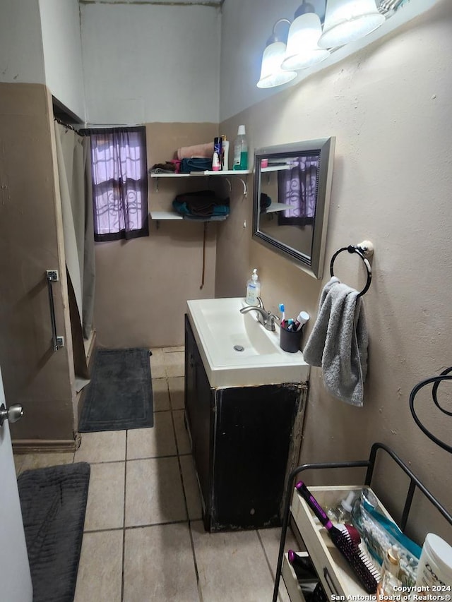 bathroom featuring vanity, walk in shower, and tile patterned flooring