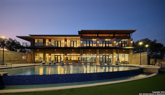 704 Teakmill Trl, San Marcos, TX 78666 - back of house featuring a patio, an infinity pool, and a balcony