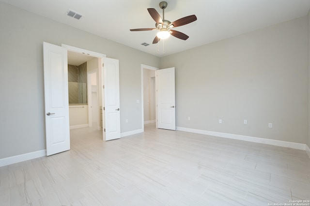 unfurnished bedroom with light tile patterned flooring and ceiling fan