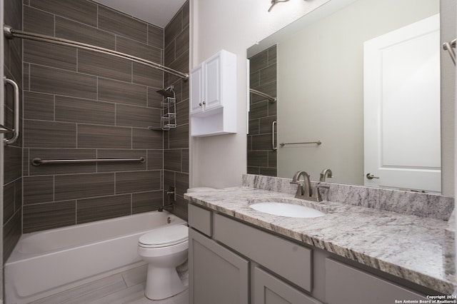 full bathroom featuring tile patterned floors, vanity, tiled shower / bath combo, and toilet