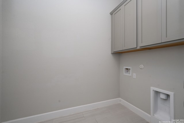 clothes washing area featuring washer hookup, cabinets, and hookup for a gas dryer