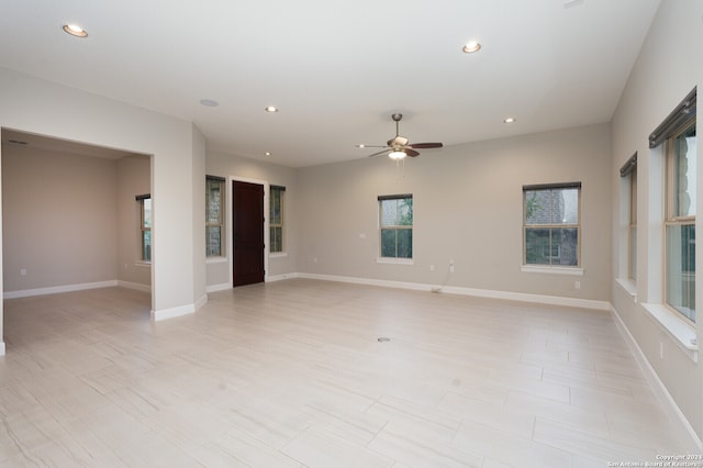 unfurnished living room featuring ceiling fan