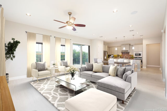 living room featuring sink and ceiling fan