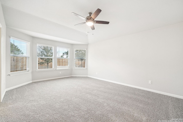 unfurnished room with ceiling fan and carpet