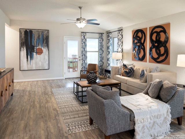 living room with ceiling fan, lofted ceiling, and hardwood / wood-style flooring