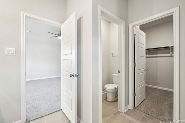 bathroom with tile patterned floors, ceiling fan, and toilet