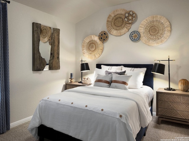 bedroom featuring vaulted ceiling and carpet flooring