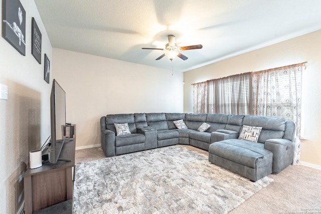 living room with ceiling fan, carpet floors, and a textured ceiling