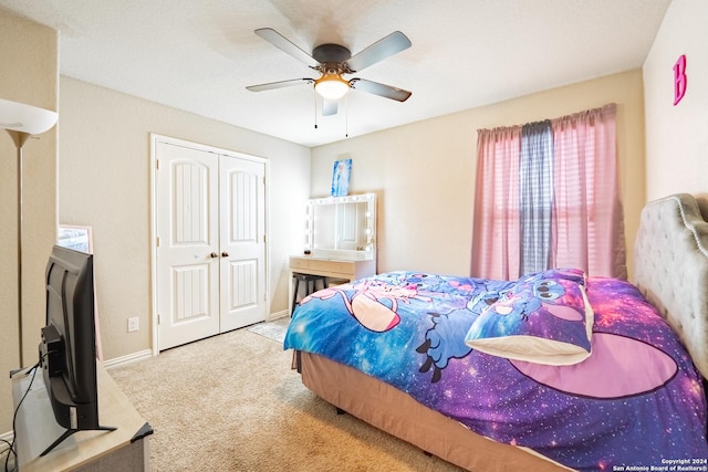 carpeted bedroom featuring ceiling fan and a closet