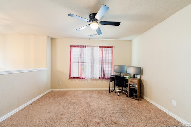 carpeted home office featuring ceiling fan and a textured ceiling