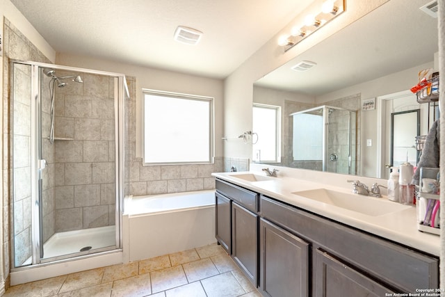 bathroom featuring tile patterned floors, shower with separate bathtub, and vanity