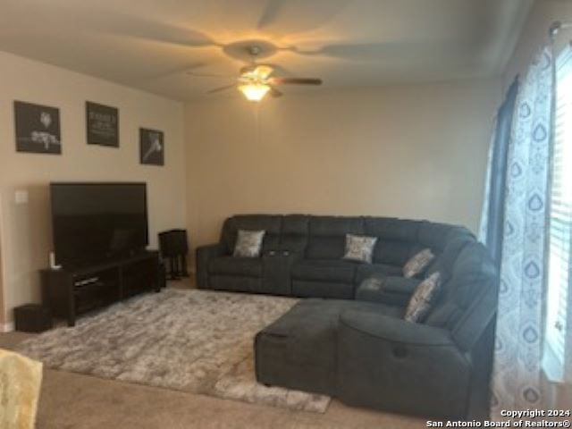 living room with carpet and ceiling fan