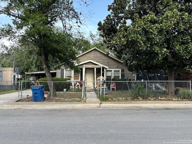 view of front of house featuring a fenced front yard and a carport