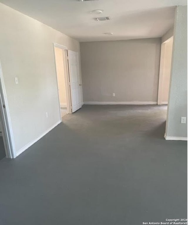 unfurnished room featuring concrete floors