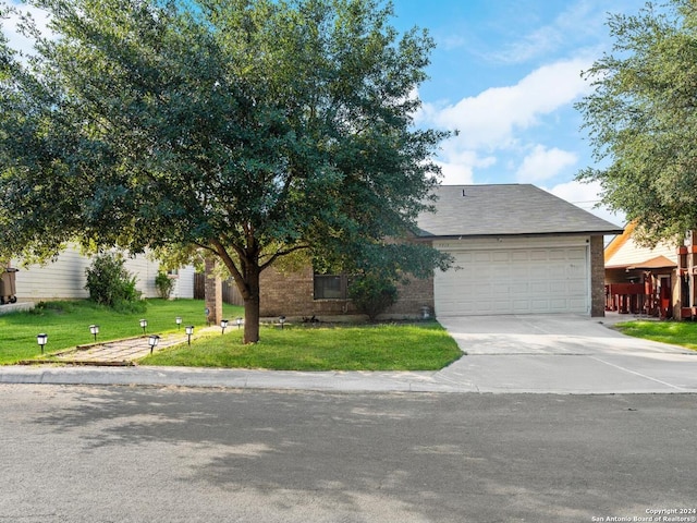 view of front of property with a front yard and a garage