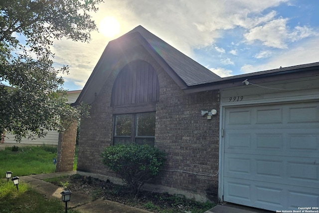 view of front facade with a garage and brick siding