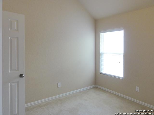 unfurnished room with light carpet