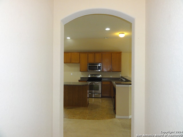 kitchen featuring sink, tile patterned flooring, and stainless steel appliances