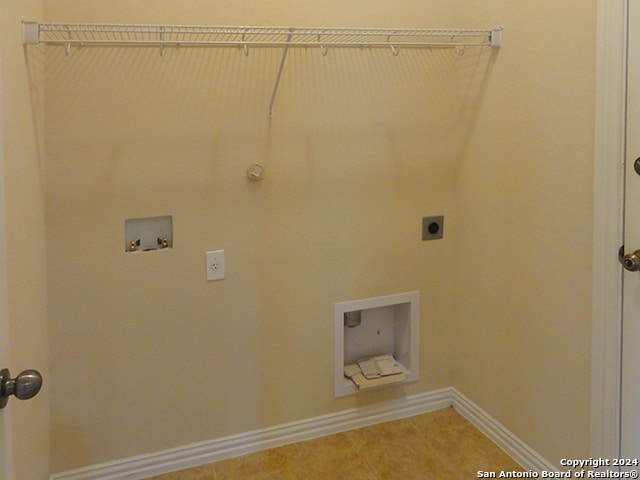 washroom featuring gas dryer hookup, hookup for an electric dryer, tile patterned flooring, and washer hookup