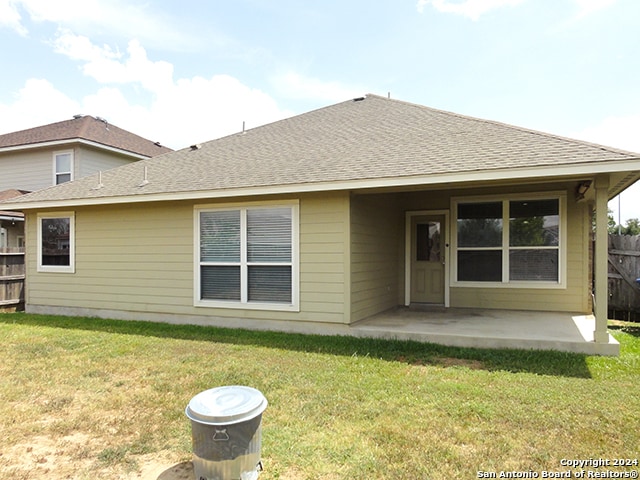 rear view of property with a patio and a yard