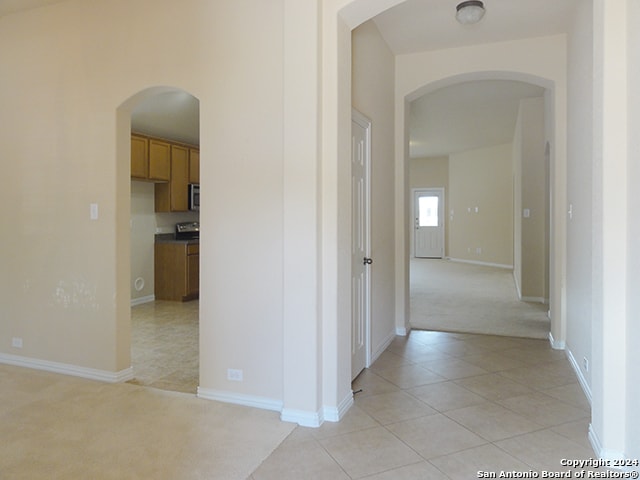 hall with light tile patterned floors