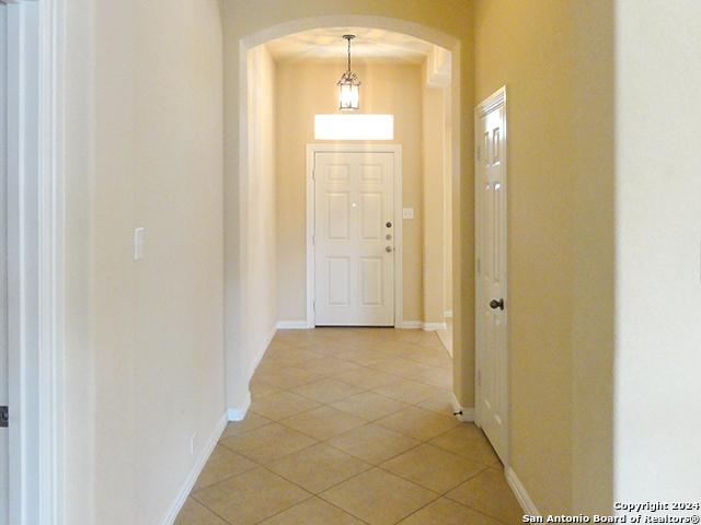 hall with light tile patterned floors