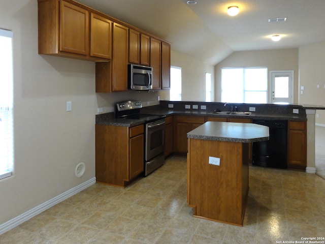 kitchen with appliances with stainless steel finishes, vaulted ceiling, sink, light tile patterned floors, and a kitchen island