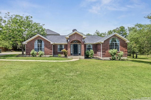 ranch-style home featuring a front yard and french doors