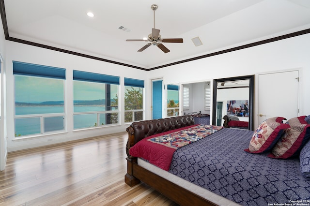 bedroom featuring multiple windows, ceiling fan, light wood-type flooring, and crown molding