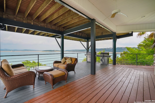 deck featuring a water view and ceiling fan