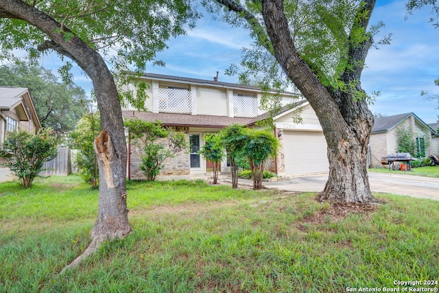 view of front of house featuring a garage and a front lawn