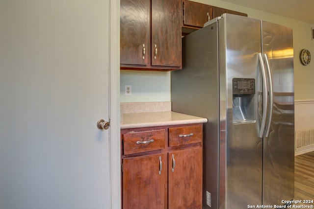 kitchen featuring stainless steel fridge and wood-type flooring