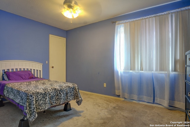 carpeted bedroom featuring ceiling fan