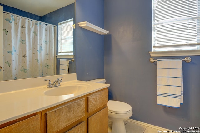 bathroom featuring vanity, tile patterned floors, and toilet