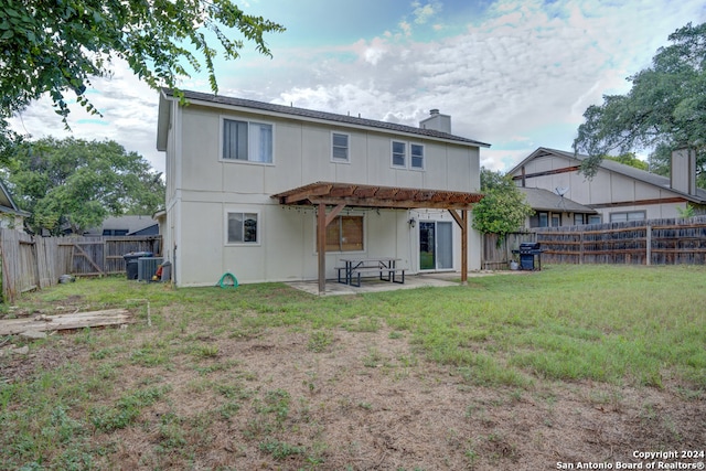 back of property featuring a pergola, a patio area, and a lawn